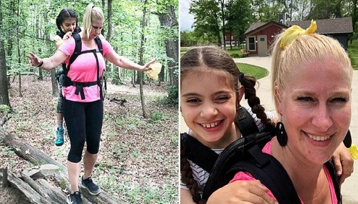 10 years old with cerebral palsy, carried by her teacher on a hike